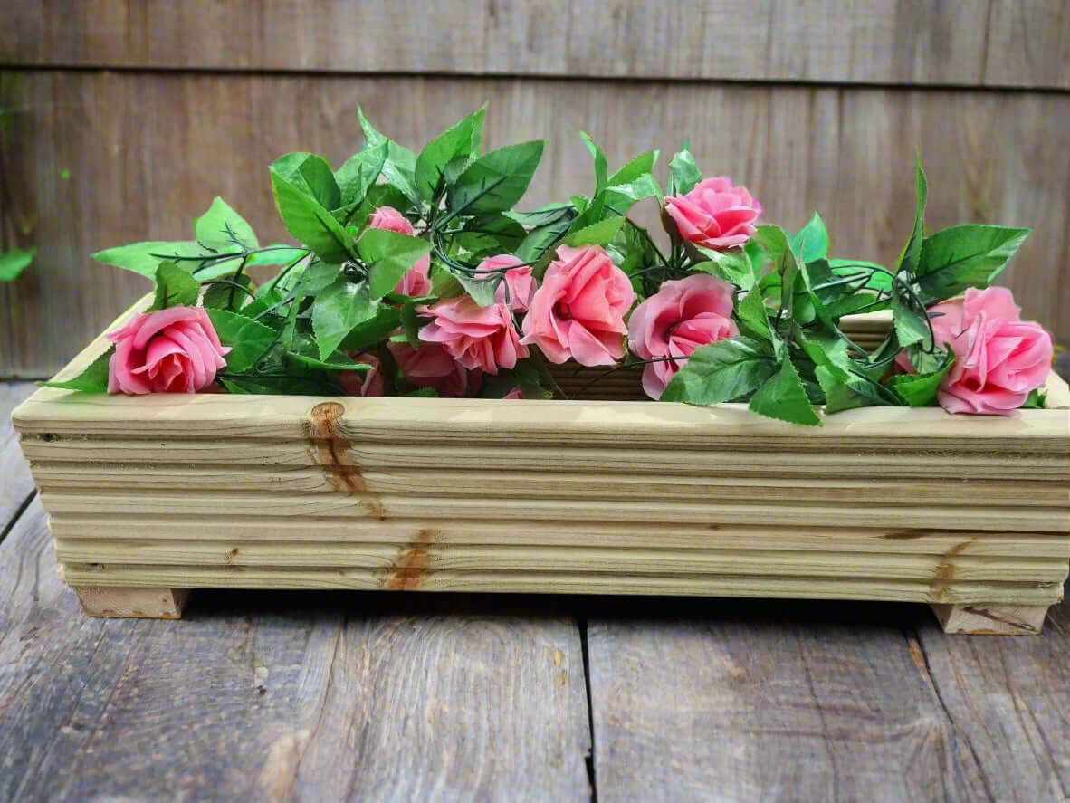 22cm Wide Wooden Decking Planters filled with pink roses and green leaves, ideal for outdoor decor.