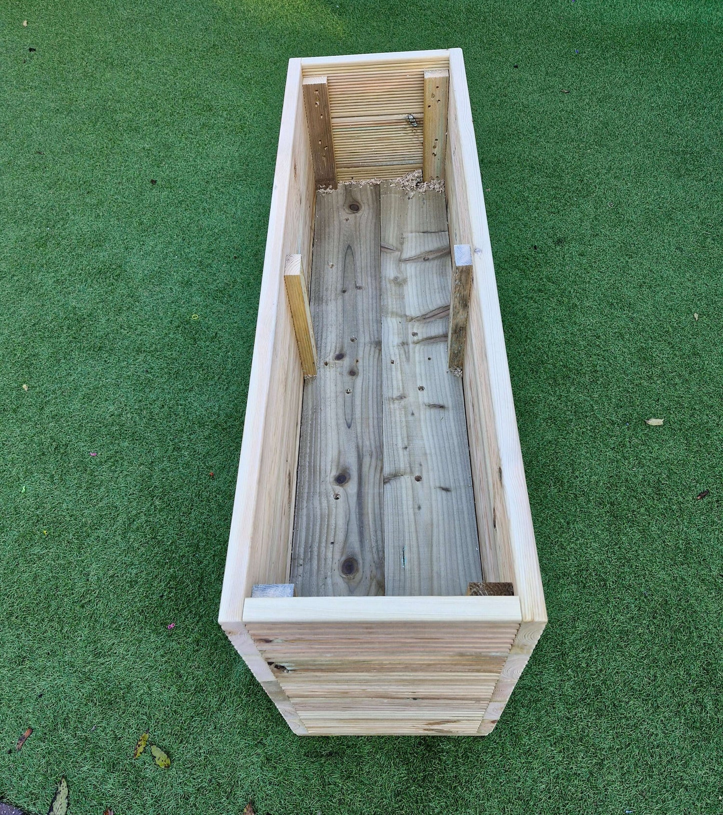 40cm Wide garden wooden decking planter view from above on green grass
