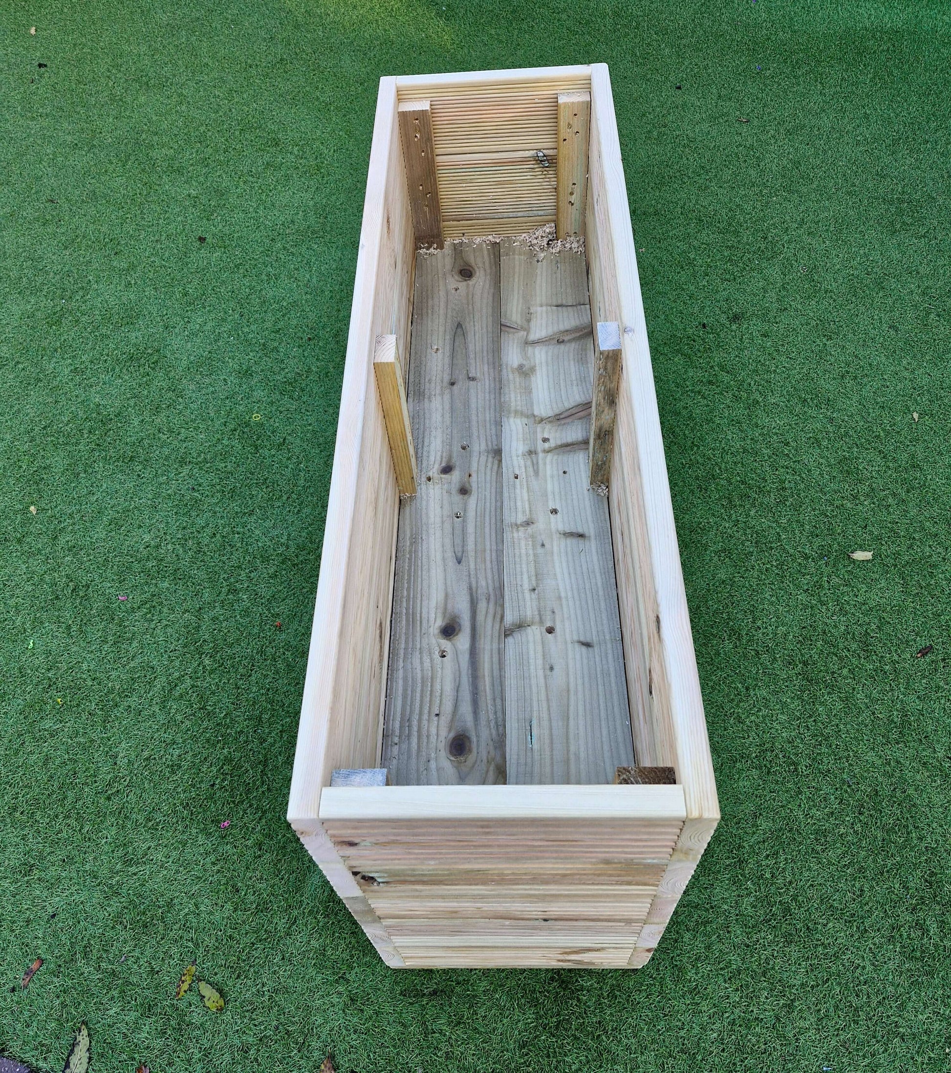 40cm Wide garden wooden decking planter view from above on green grass